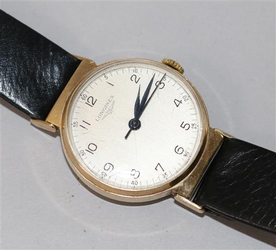 A 9ct gold-cased Longines gentlemans wristwatch, with white Arabic dial and blued steel hands, on black leather strap.